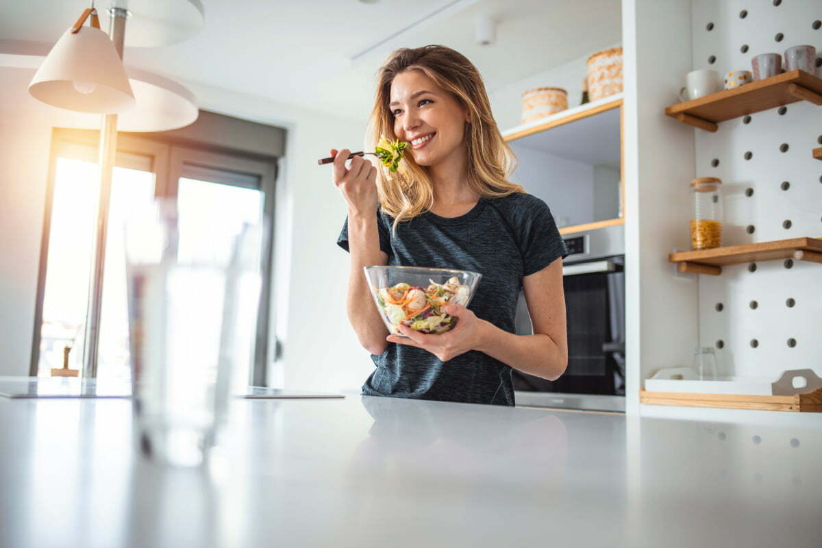 Woman Enjoying Salad as part of Nutritious Diet Pre-Surgery