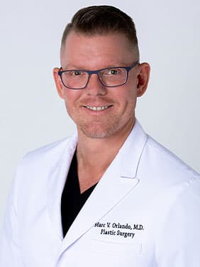 Image of Dr. Orlando smiling in a white coat