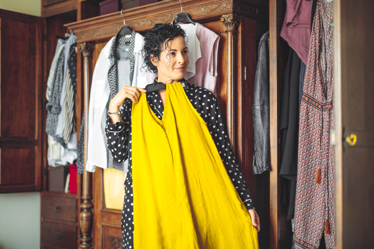 Woman trying on loose clothes to wear during her tummy tuck recovery