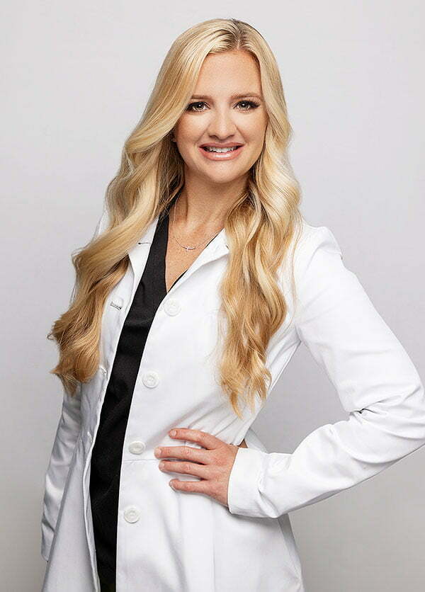 Dr. Haley Bray smiling in a white coat