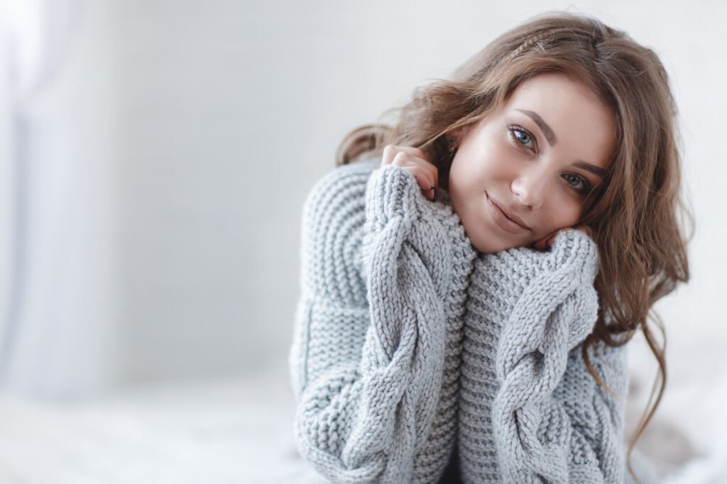 Smiling woman in gray sweater