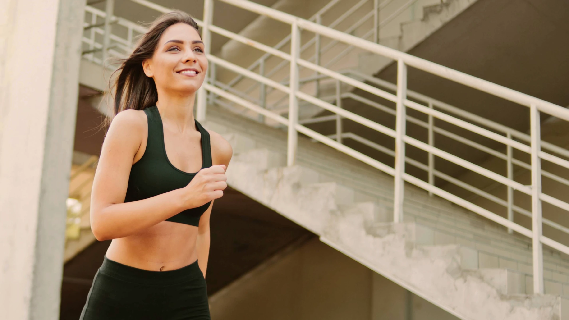 happy confident woman running in athletic outfit