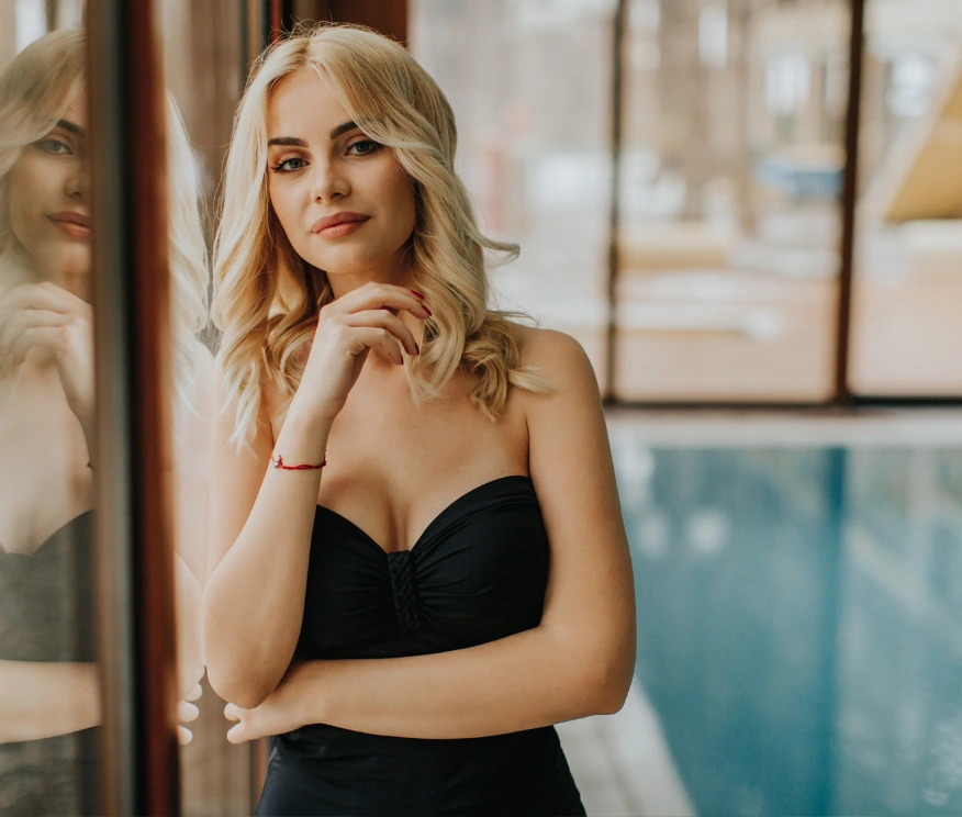 confident woman wearing strapless swimsuit by the pool