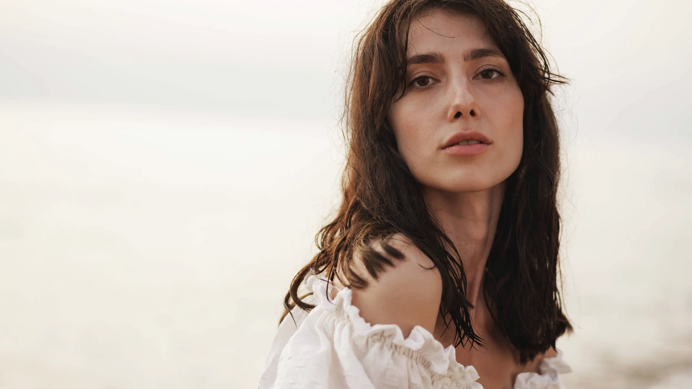 beautiful young woman with defined cheekbones at the beach