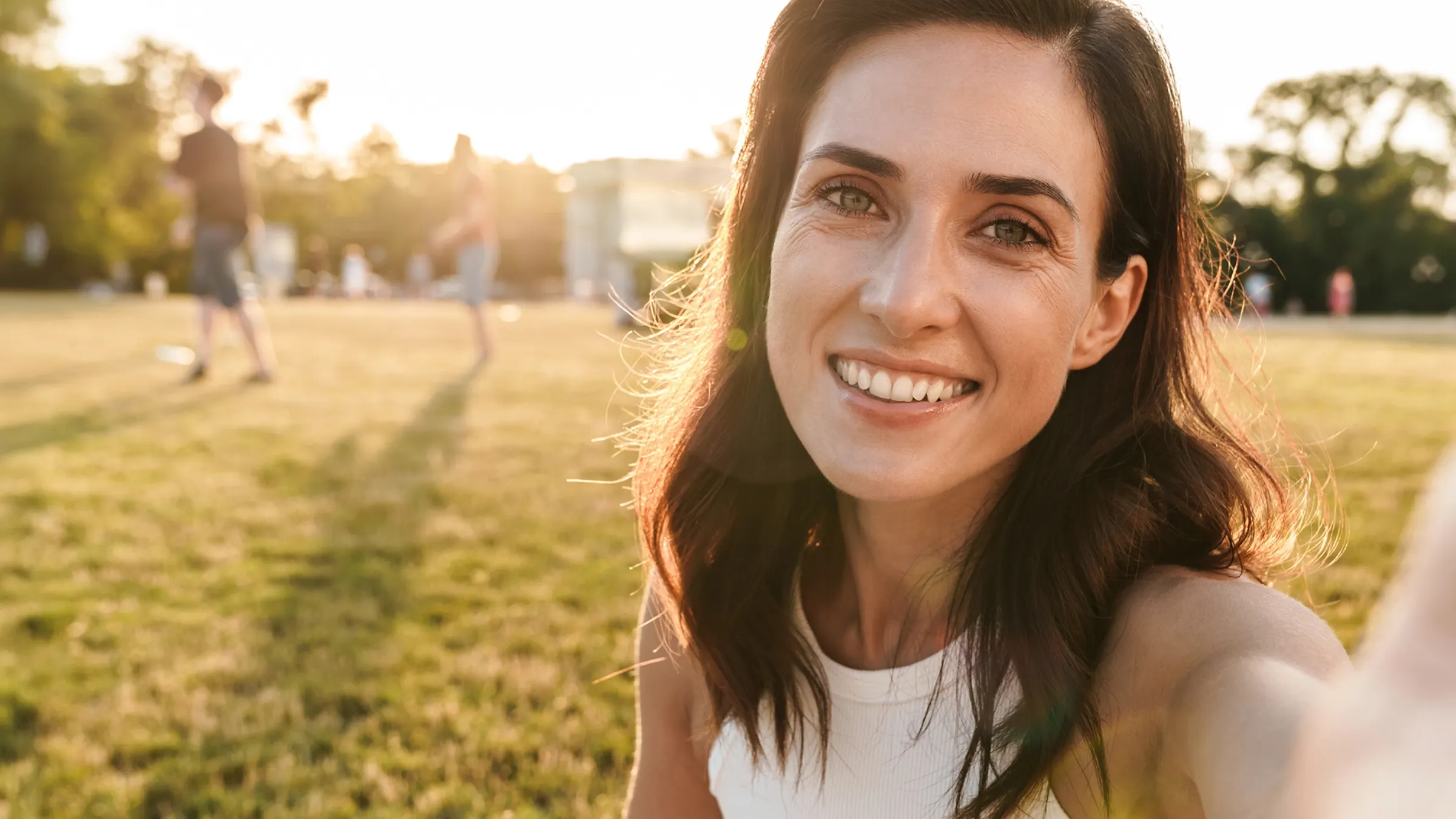 happy middle-aged woman with beautiful eyes at park