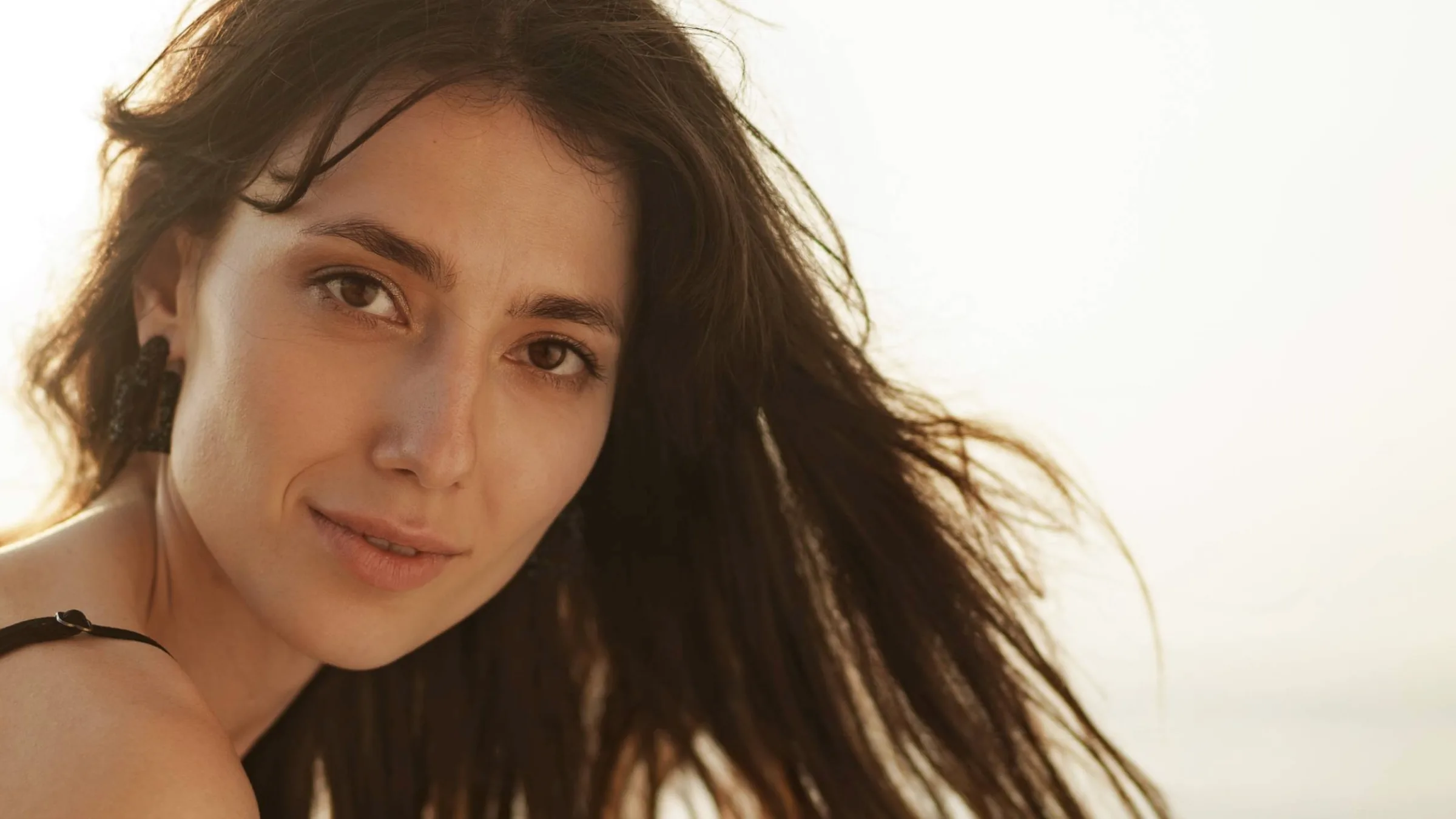 30's woman with beautiful facial features at the beach