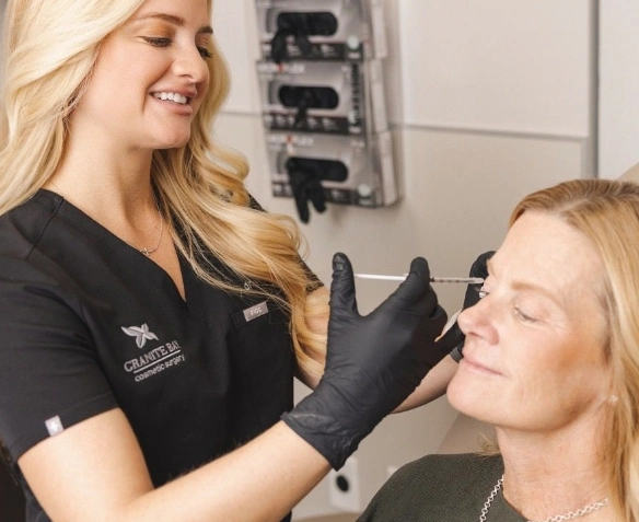 Dr. Bray giving injections to patient's eye area