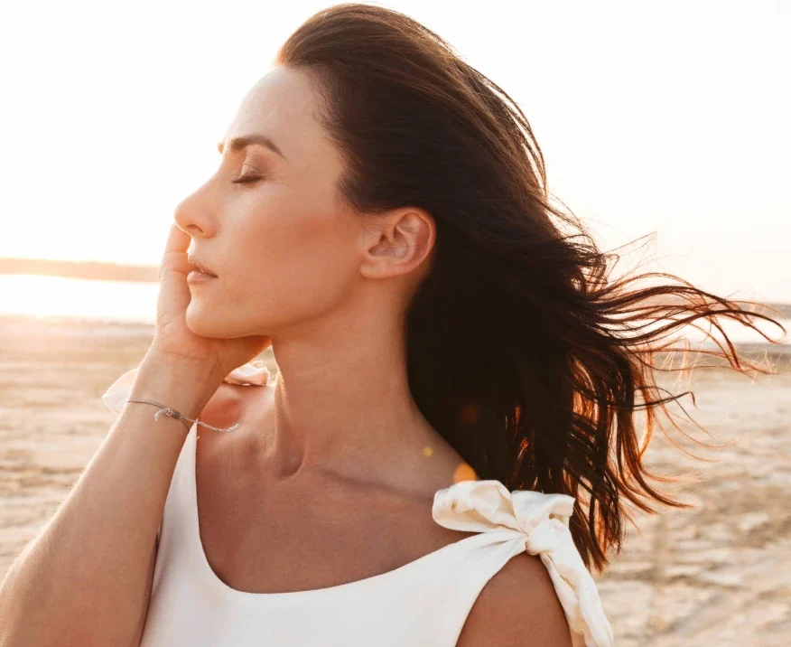 side profile of beautiful middle-aged woman on the beach