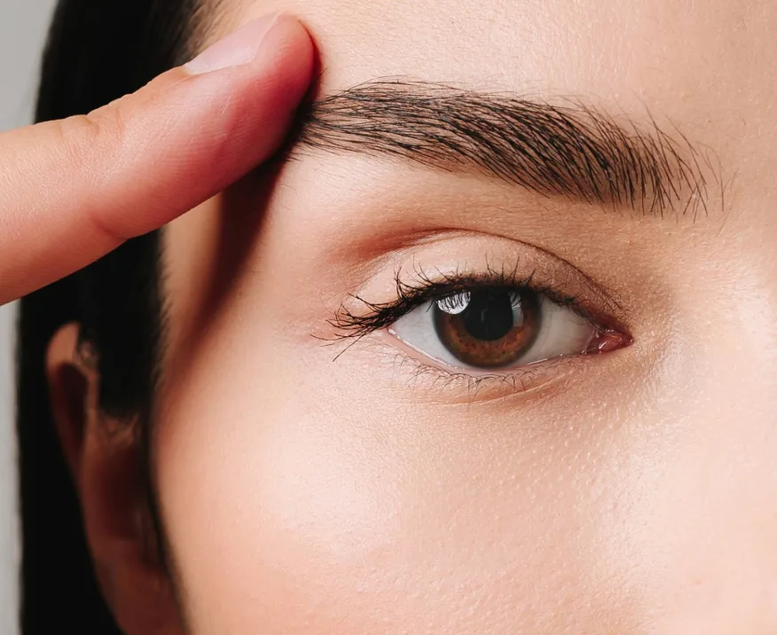 close up of woman touching upper eyelid