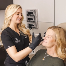 Dr. Bray treating patient's wrinkles with injection