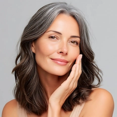 mature woman touching face