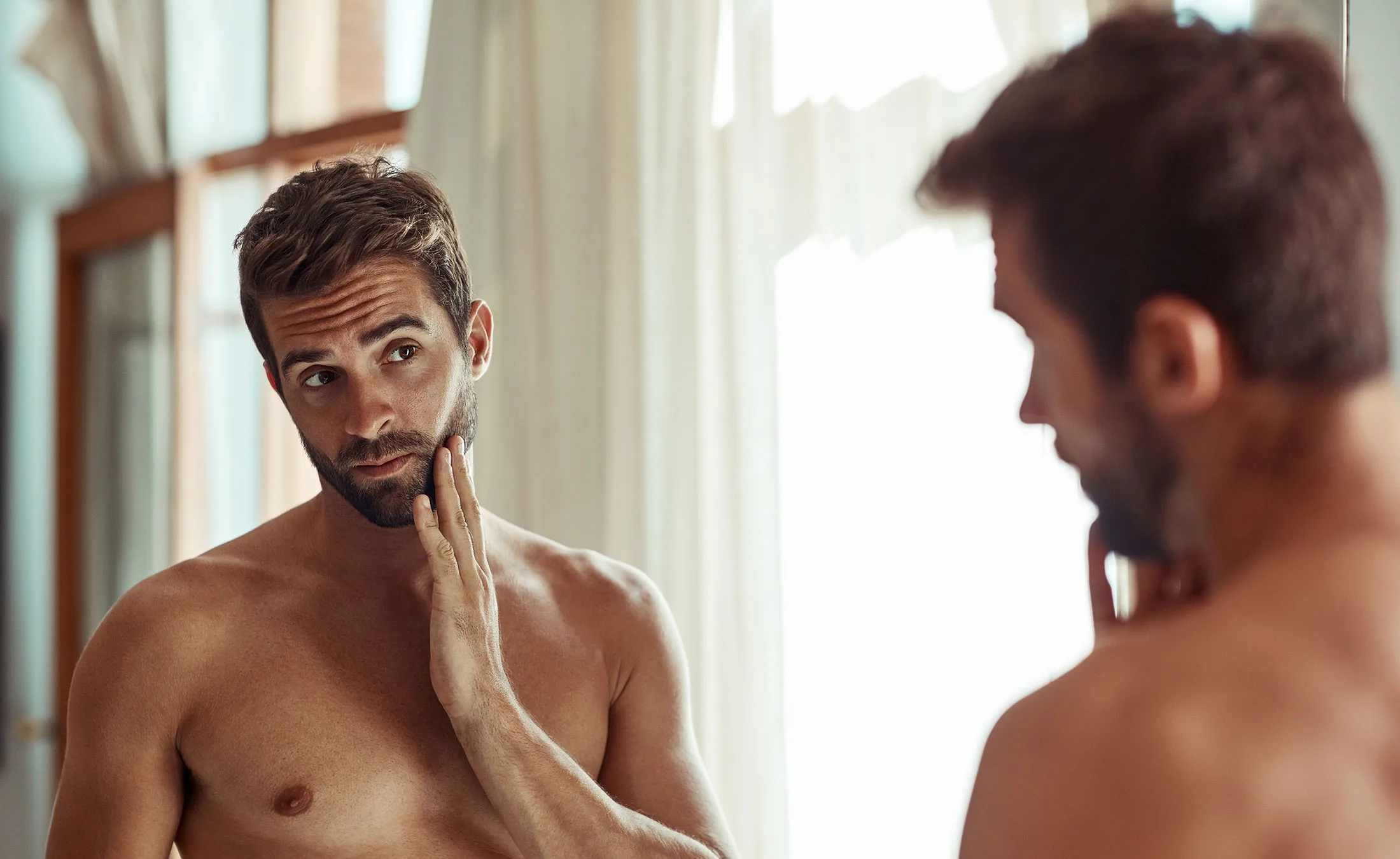 handsome man looking in the mirror