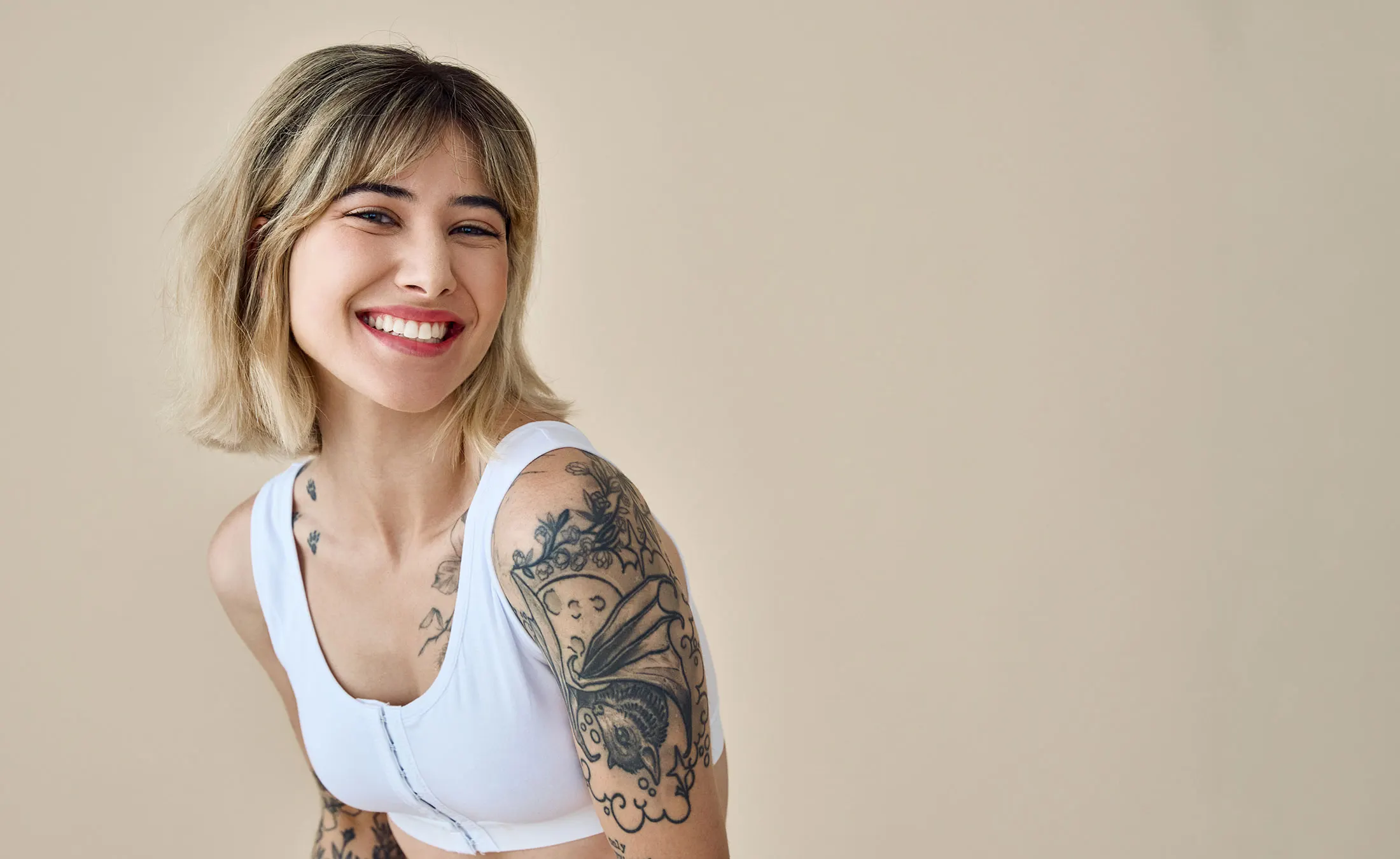 Smiling tattooed blond