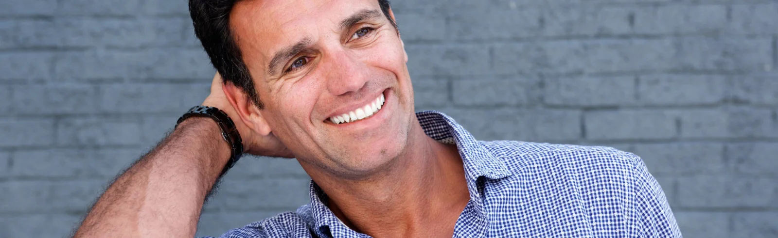 attractive middle-aged man smiling with clear skin
