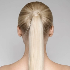back of woman's head with hair in ponytail showcasing symmetrical ears