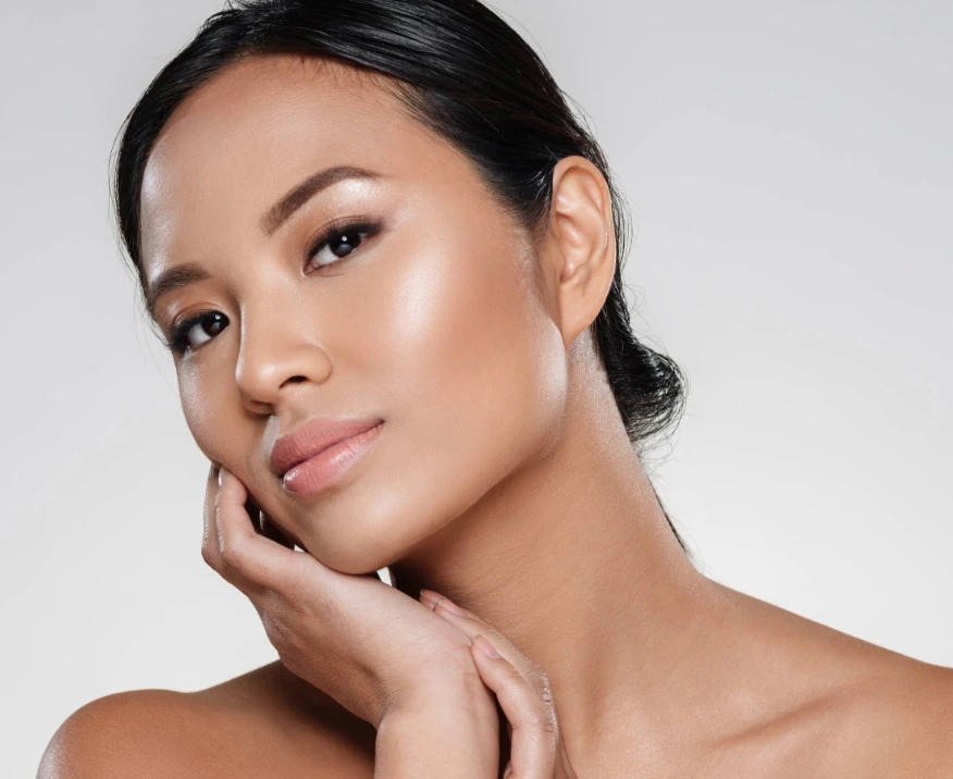 woman touching radiant, clear skin