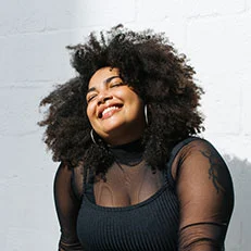 Cheerful female model in black stylish wear