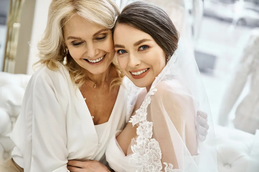 mother and bride smiling together
